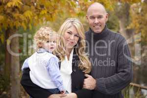 Young Attractive Parents and Child Portrait in Park
