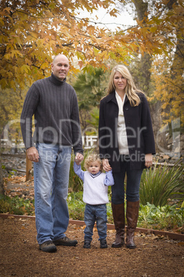 Young Attractive Parents and Child Portrait in Park