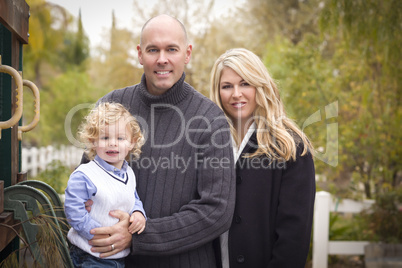 Young Attractive Parents and Child Portrait in Park