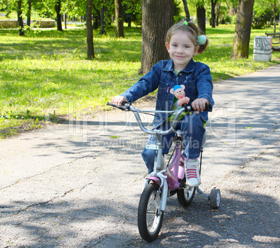 child riding bicycle in park