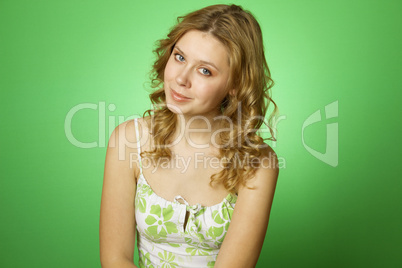 Beautiful young woman on green background