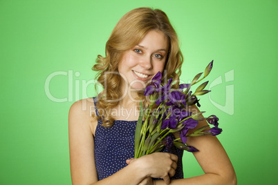 Attractive girl hugging a bouquet of iris