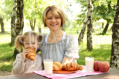 mother and daughter breakfast in nature