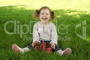 happy young girl sitting on grass in park