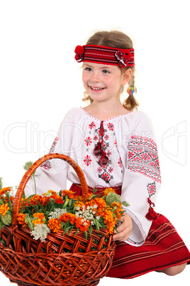 Little girl in the national Ukrainian costume sitting on his kne