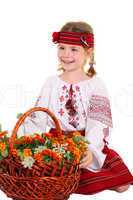 Little girl in the national Ukrainian costume sitting on his kne
