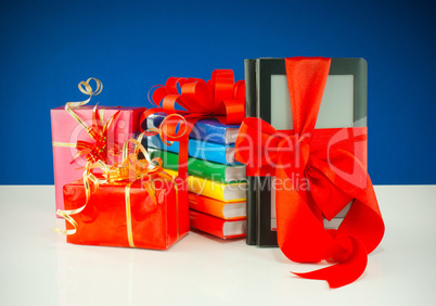 Christmas presents with electronic book reader against blue background