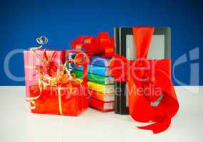 Christmas presents with electronic book reader against blue background