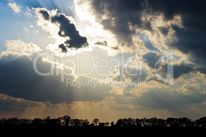 Sun Rays Beam through Dark Ominous Clouds