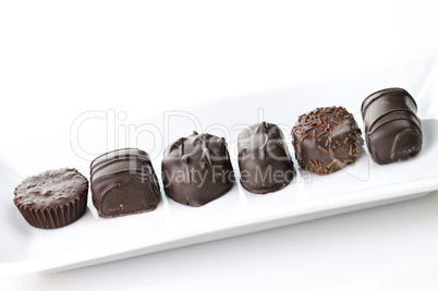 chocolate candies assortment in a white plate