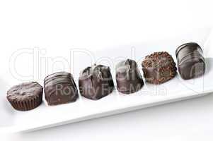 chocolate candies assortment in a white plate