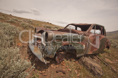 Old abandoned car with bullet holes