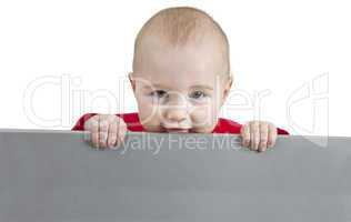 young child holding grey sign