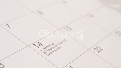 Red heart in calendar on the date of 14 february