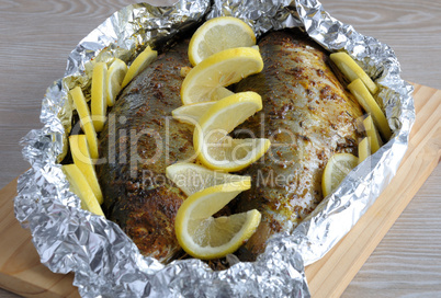 Baked herring in spices and herbs in foil