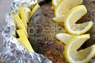 Baked herring in spices and herbs in foil