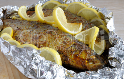 Baked herring in spices and herbs in foil