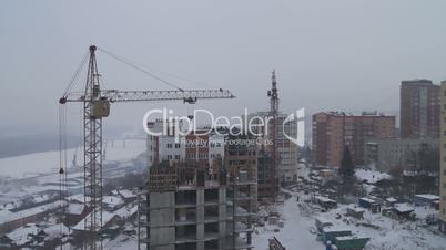 Winter construction. With the boom of a crane.