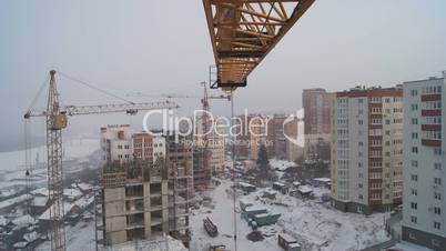 Winter construction. With the boom of a crane.