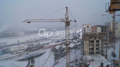 Winter construction. With the boom of a crane.