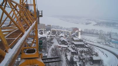 Winter construction. With the boom of a crane.