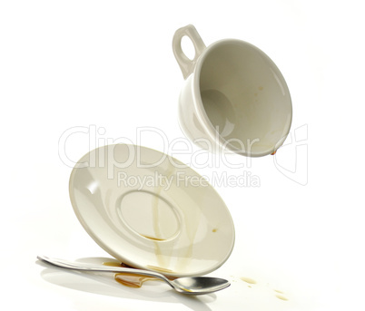 Cup and saucer with spilled coffee