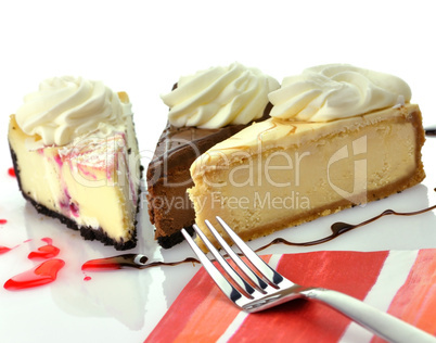 slices of cheesecakes with fork and napkin