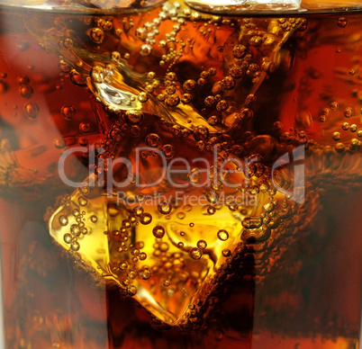 cola with ice cubes close up