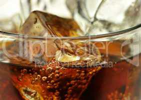 cola with ice cubes close up