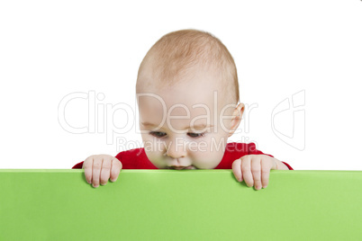 young child holding green shield