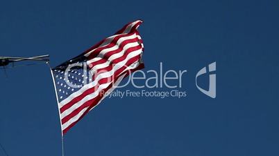 USA flag flying on the wind on blue sky background