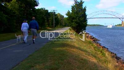 Cape Cod Canal; couple walking dog