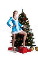 Pretty christmas girl stand with new year fir tree
