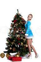 Young christmas girl decorate new year fir tree