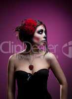 Young woman in day of the dead mask skull face art