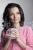 woman in rose jacket with cup of tea