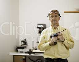 Senior man holding power drill