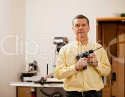 Senior man holding power drill