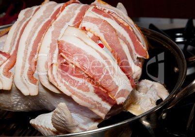 Bacon laid on turkey for roasting