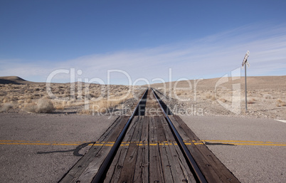 Railroad crossing tracks in the desert