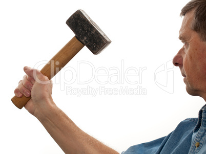 Senior man holding a large hammer