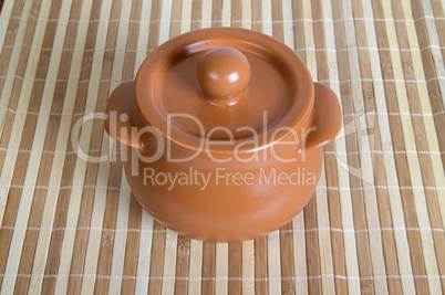 Ceramic pot on the striped mat