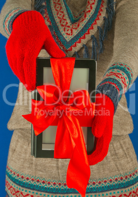 Girl holds electronic book reader with red gloves