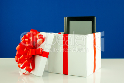 Electronic book reader in a box against blue background