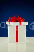Open white box with present against blue background