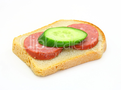 sandwich with sausage and a cucumber