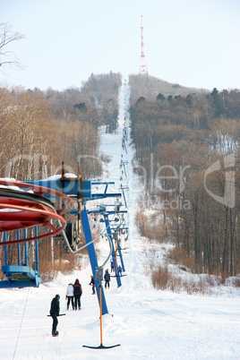 Skiers go on the lift on mountain
