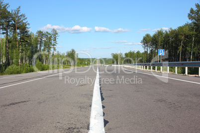 Asphalt  road and sky with  clouds