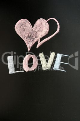Love with two hearts drawn on a chalkboard