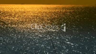 Sparkling water surface and fishing rod,horizon,skyline.